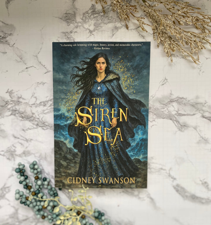 A paperback copy of The Siren Sea by Cidney Swanson — clean YA fantasy for ages 12+, first in the Five Kingdoms Chronicles.