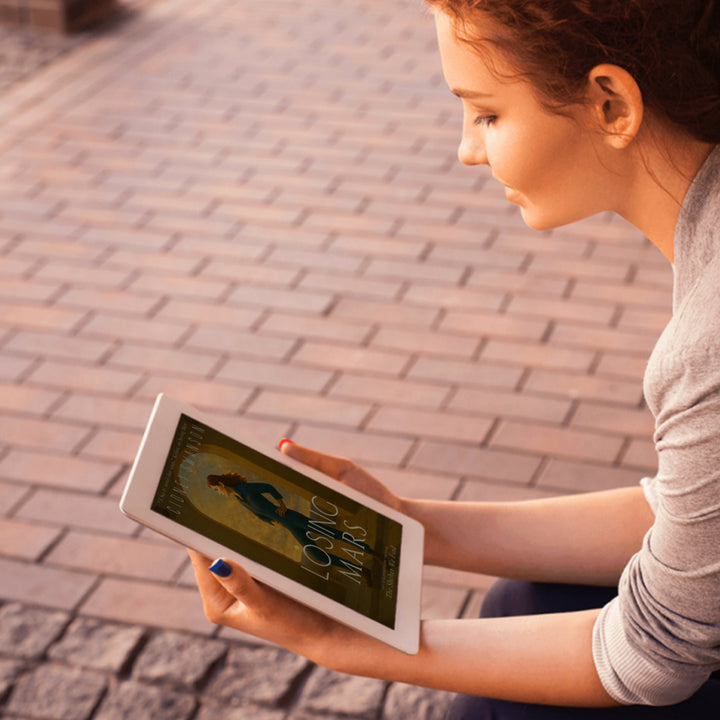 Young woman reading Losing Mars by Cidney Swanson | clean YA sci-fi for ages 10+, part of the Saving Mars series.