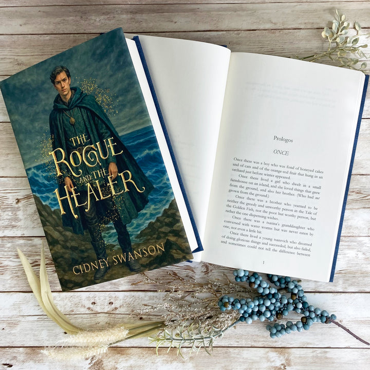 Open page of The Rogue and the Healer by Cidney Swanson | lyrical YA fantasy for ages 12–17, part of the Five Kingdoms Chronicles.