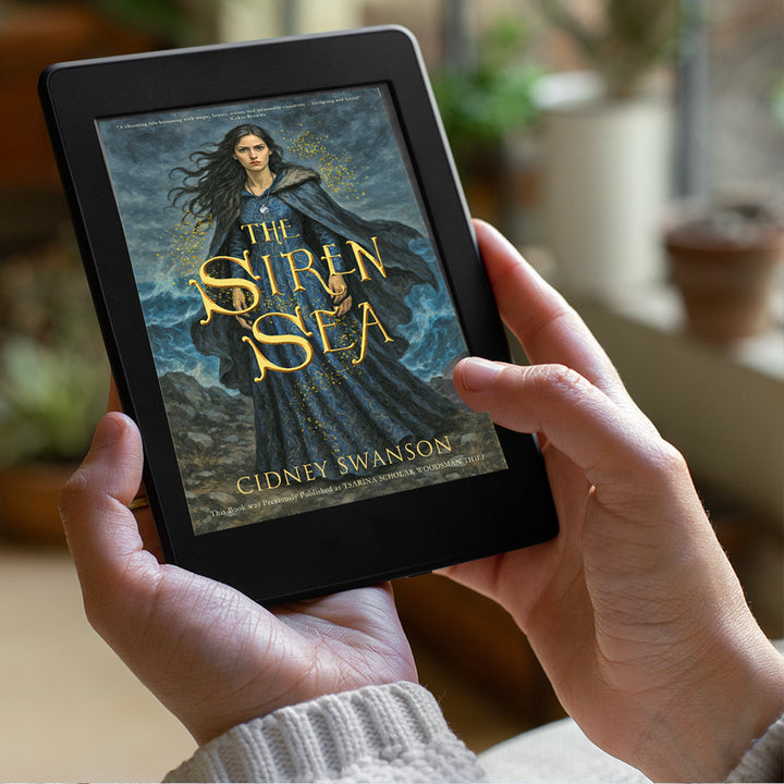 person holding The Siren Sea by Cidney Swanson | lyrical YA fantasy for ages 12–17, part of the Five Kingdoms Chronicles.
