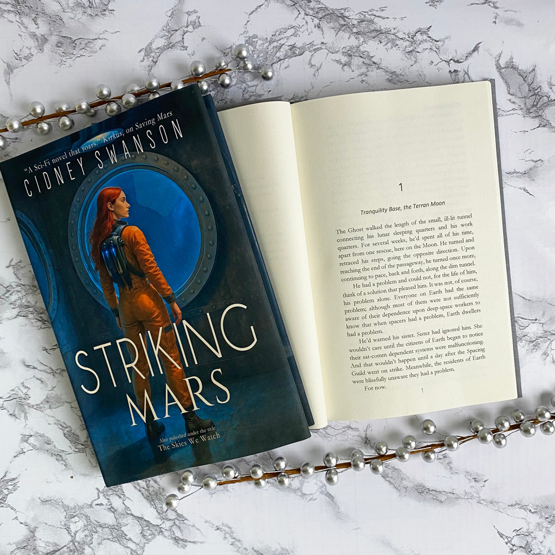 Open copy of Striking Mars by Cidney Swanson | clean YA sci-fi for ages 10+, part of the Saving Mars series.