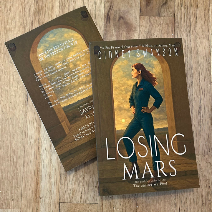 Book cover of 'Losing Mars' by Cidney Swanson on a wooden surface