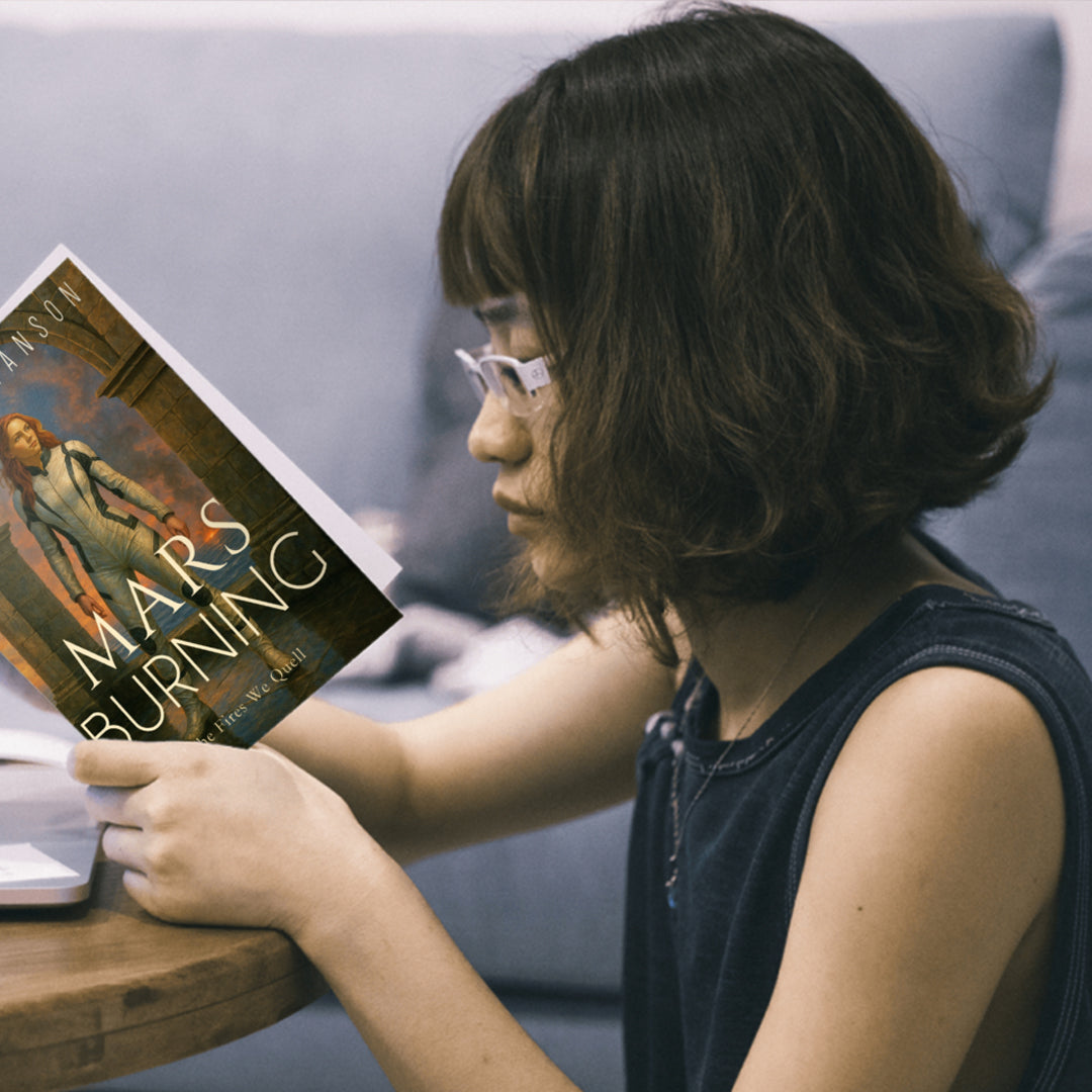 Young woman reading Mars Burning by Cidney Swanson — clean YA sci-fi for ages 10+, fourth in the Saving Mars series.
