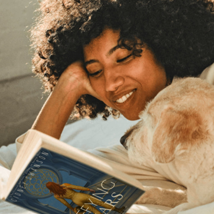 Teen reading Defying Mars by Cidney Swanson — clean YA sci-fi for ages 10+, second in the Saving Mars series.