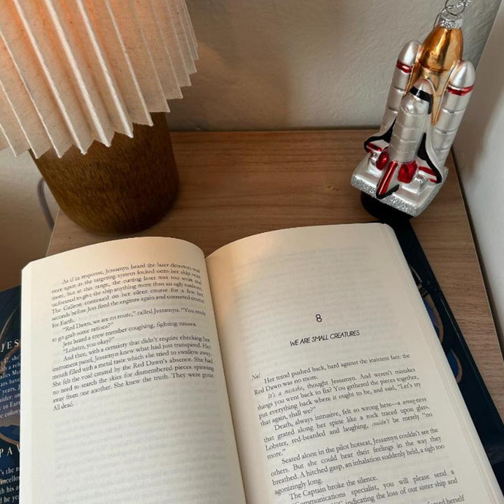 Saving Mars Hardcover bundle on wooden surface alongside memorabilia