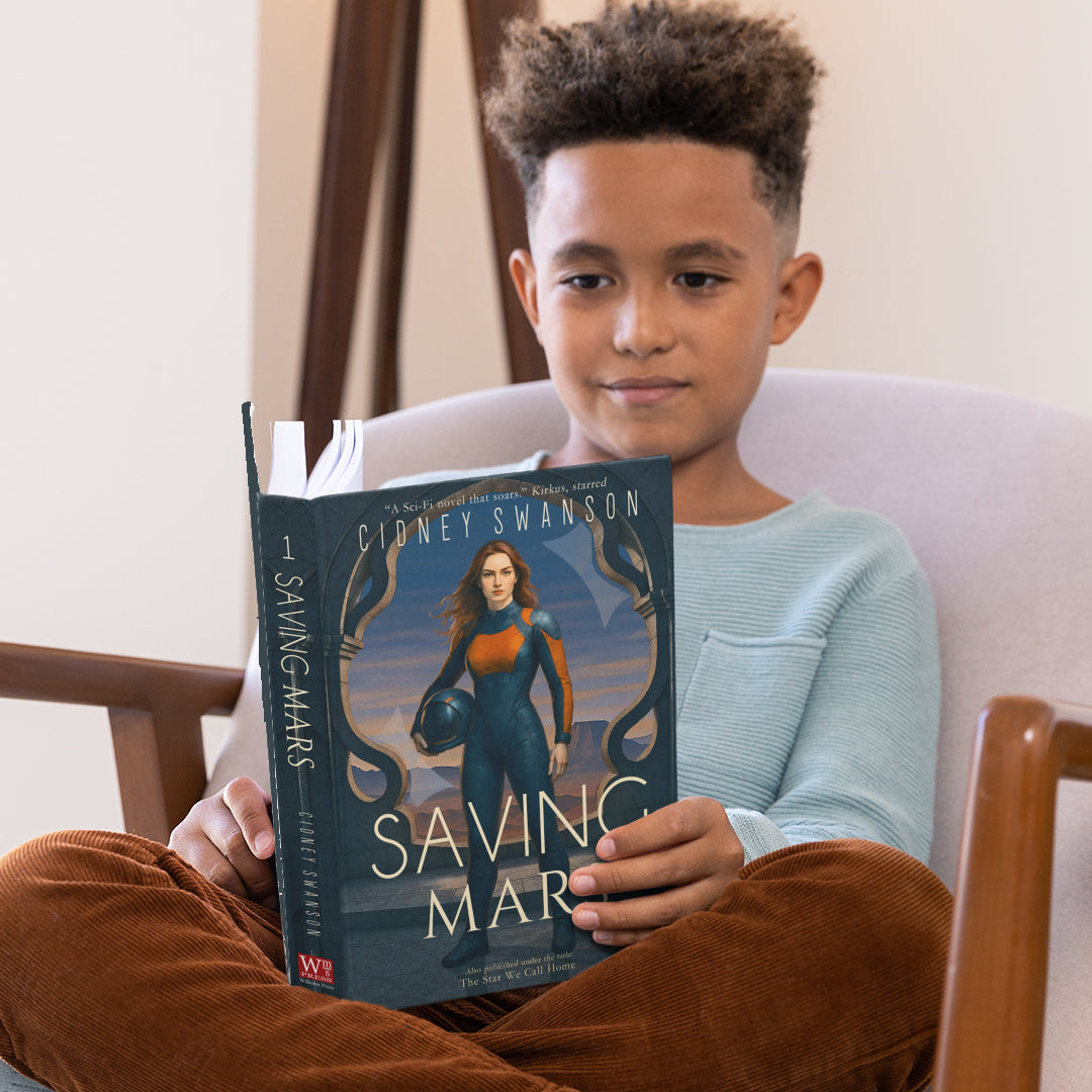 Boy reading Saving Mars by Cidney Swanson | clean YA sci-fi for ages 10+, part of the Saving Mars series.
