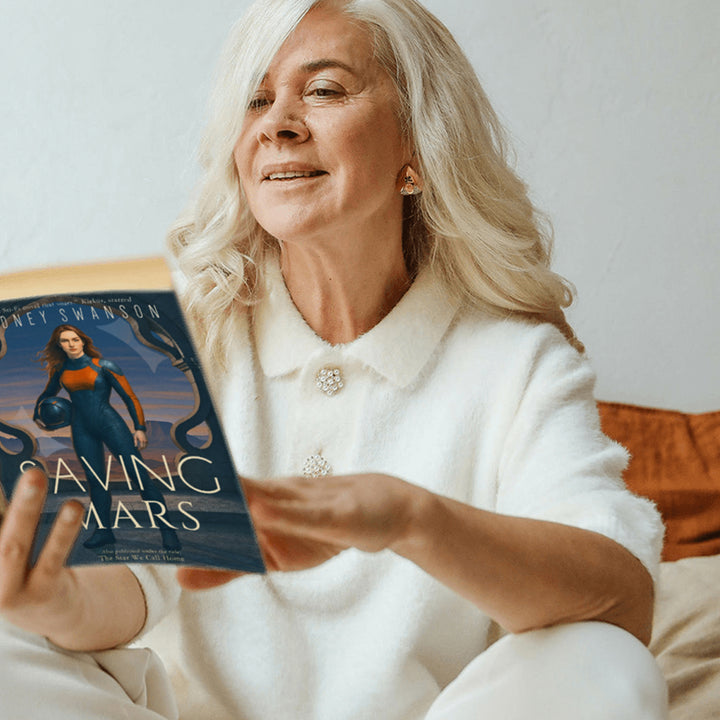Mature woman reads Saving Mars by Cidney Swanson | clean YA sci-fi for ages 10+, part of the Saving Mars series.