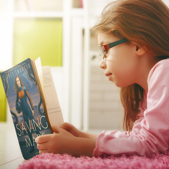 Girl reading Saving Mars by Cidney Swanson | clean YA sci-fi for ages 10+, part of the Saving Mars series.