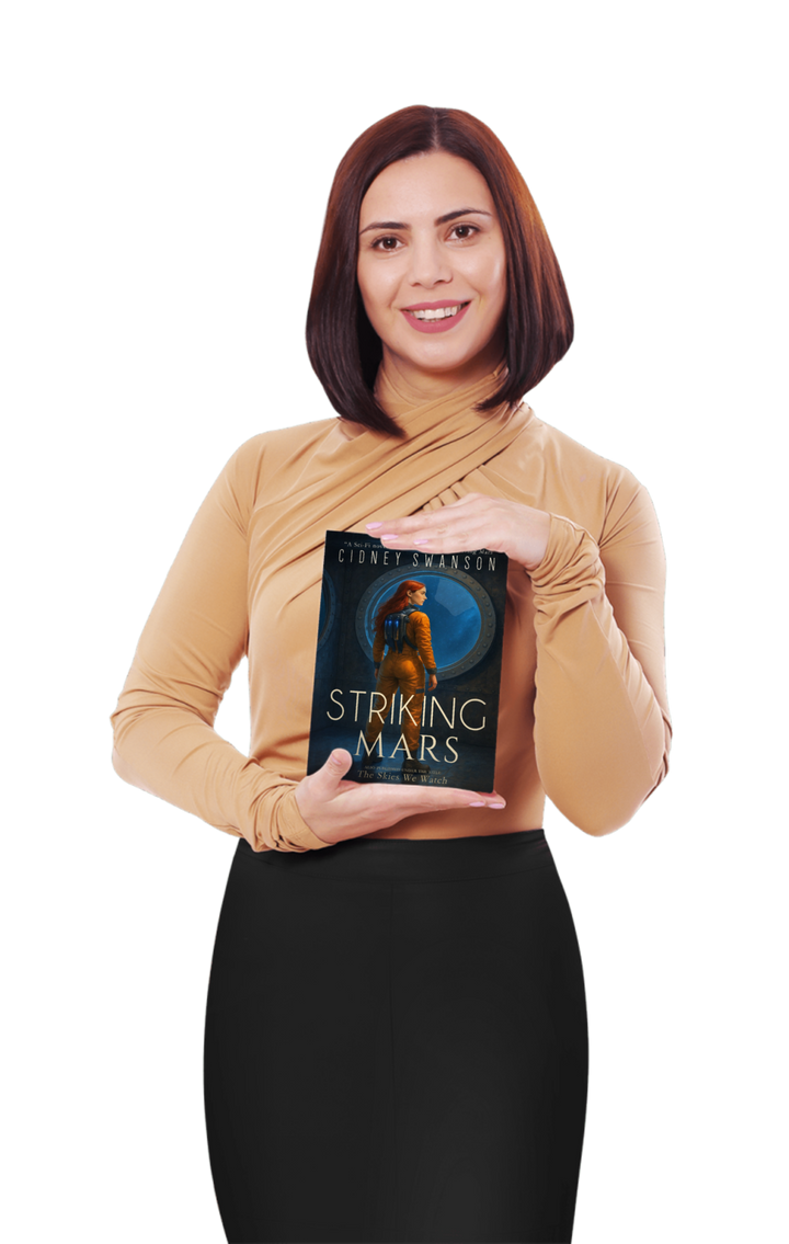 A smiling mom holding Striking Mars by Cidney Swanson — clean YA sci-fi for ages 10+, fifth in the Saving Mars series