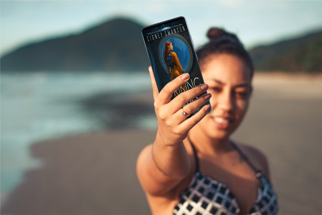 Young woman holds Striking Mars by Cidney Swanson | clean YA sci-fi for ages 10+, part of the Saving Mars series.