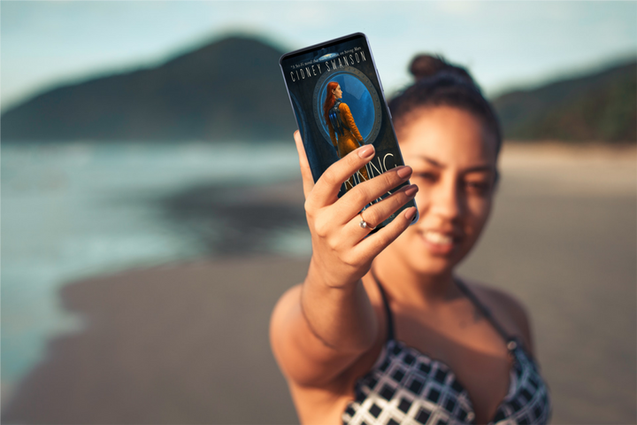 Young woman holds Striking Mars by Cidney Swanson | clean YA sci-fi for ages 10+, part of the Saving Mars series.