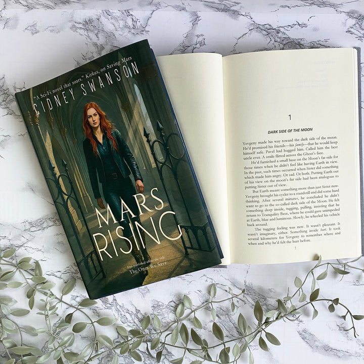 Open copy of Mars Rising by Cidney Swanson | clean YA sci-fi for ages 10+, part of the Saving Mars series.